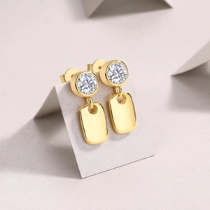 Close-up of S925 silver 18k gold earrings with moissanite and mirror metal plates