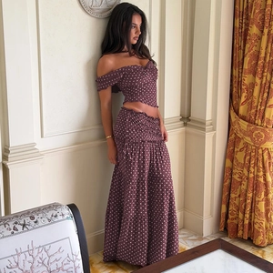 Close-up of tiered burgundy polka dot maxi skirt with detailed smocking and ruffles