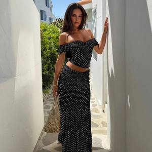 Detail of elegant black and white polka dot two-piece set with a crop top and maxi skirt