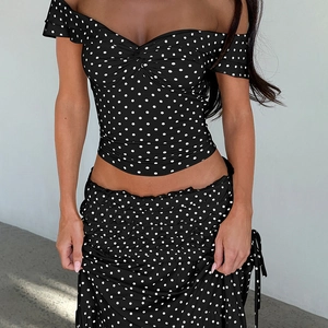 Detail of polka dot crop top and pleated maxi skirt set with drawstring side tie