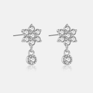 Detail view of flower-shaped 925 silver earrings with clear zircon crystals and drop stones