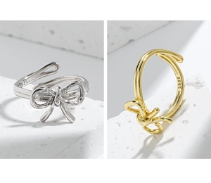 Macro detail of S925 sterling silver stamp on minimalist bow-shaped open rings