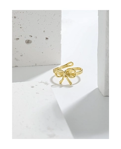 Macro view of gold bow-shaped S925 sterling silver ring with internal logo engraving