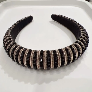 Detail of handcrafted sponge headband featuring black crystal beads and silver stripe patterns