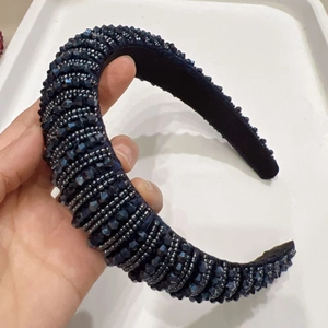 Detail of dark blue wide sponge headband with hand-sewn crystal beads and rich texture