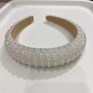 Detailed view of padded headband featuring hand-beaded crystals and non-slip lining