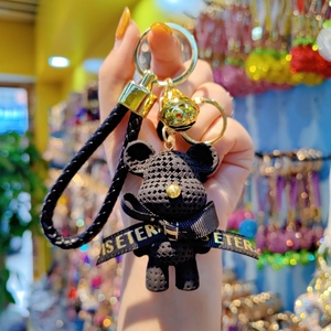 Creative black knit-texture bear keychain with gold bell and leather strap ornament