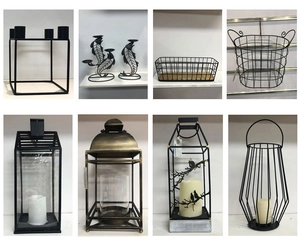 Detail of vintage iron candle holders and geometric lanterns with glass covers in black