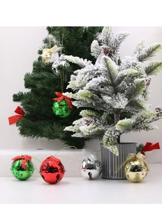 Detail of Christmas bell ornaments with cutout Joy lettering and festive bows
