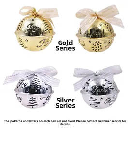 Detail of gold and silver Christmas bells with cut-out trees and festive bows