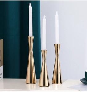 Three-piece gold taper candle holder set for elegant table decoration