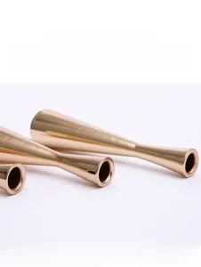 Macro detail of gold metal candle holder with a polished mirror finish texture