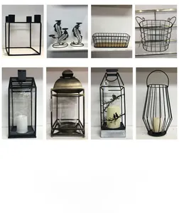Close-up of various black matte wrought iron candle holders with geometric designs