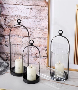 Three-piece black arched metal lanterns with glass covers in vintage home decor setting