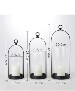 Three-piece black metal lantern set with glass cylinders and white pillar candles