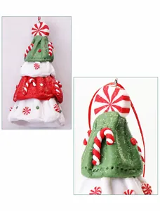 Detail of handmade Christmas tree clay ornament with festive red and white candy cane accents