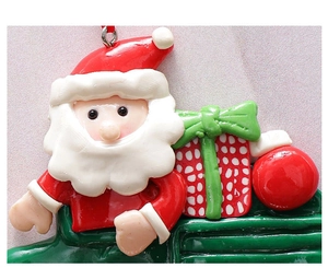 Nahaufnahme von Weihnachtsmann-Anhängern aus Harz mit Geschenkbox für den Weihnachtsbaum