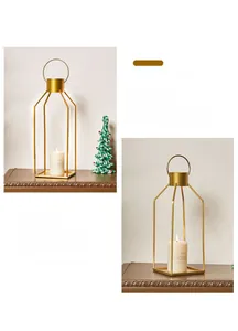 Close-up of modern gold metal frame candle holder with ring top and white pillar candle