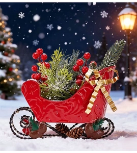 Close-up of a festive red Christmas sleigh ornament with pine branches and berries