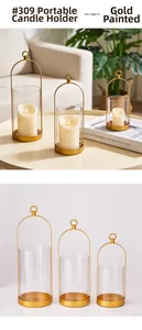 Set di tre lanterne dorate in metallo con vetri e manici ad anello per candele decorative