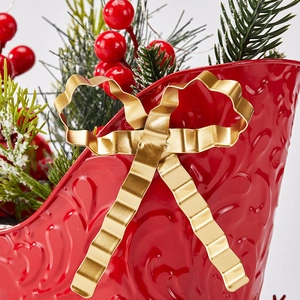 Red metal Christmas sleigh decoration with pine needles and red berries ornament