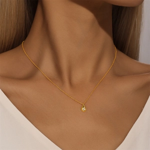 Close-up of gold S925 sterling silver teardrop necklace with sparkling zircon on neck