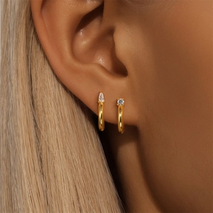 Close-up of gold S925 sterling silver C-shaped hoop earrings with teardrop zircon