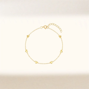 Close-up of a gold-plated heart bracelet featuring adjustable extension chain and spring clasp