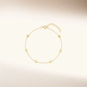 Detailed view of S925 sterling silver golden chain bracelet with six heart charms
