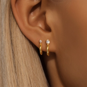 Detail of S925 silver C-shaped earrings with marquise and oval cut cubic zirconia stones
