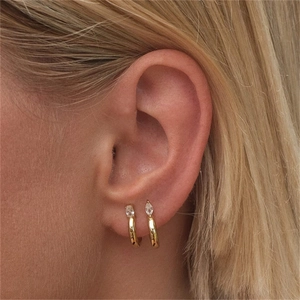 Detail of gold-plated S925 silver C-shaped hoop earrings with marquise-cut crystals