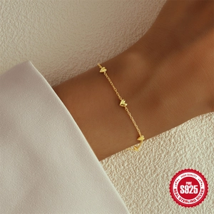 Elegant 925 sterling silver heart-shaped bracelet in gold finish worn by model