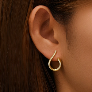 Detailed close-up of a s925 silver teardrop earring with micro-pave white zircon stones