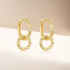 Detail of gold interlocking double hoop earrings with paved cubic zirconia stones
