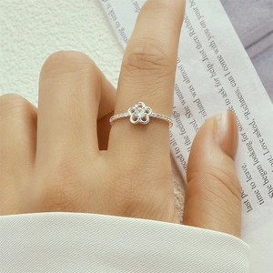 Macro shot of S925 sterling silver flower ring with pave zircon stones on model hand