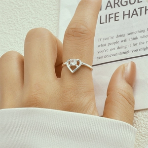 Close-up of S925 silver heart-shaped ring with a small diamond worn on hand