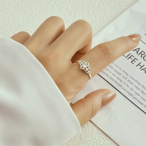 Macro view of S925 silver hollow heart ring with flower pattern and small zircon