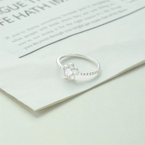 Detail of silver plum blossom ring with center stone and sparkling side diamonds
