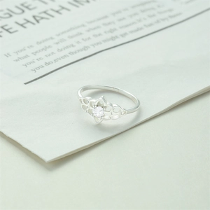 Macro shot of S925 sterling silver ring hallmark and hollow flower petal design