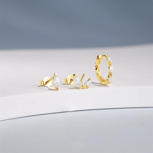 Detailed shot of S925 sterling silver gold earrings set with marquise cut zircons