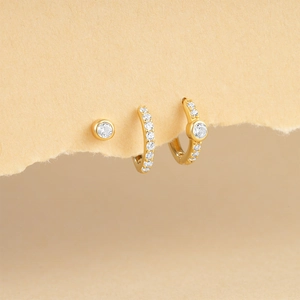 Detailed view of S925 silver star and turquoise earring set on minimalist yellow card
