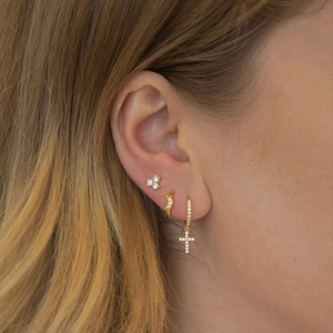 Detail view of S925 silver star moon earrings set with pavé stones on a female model