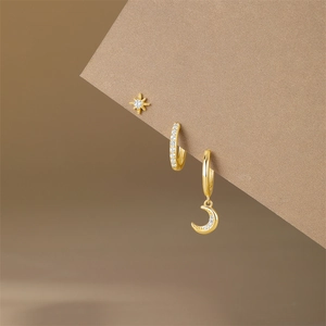Detailed close-up of S925 silver gold-plated star and moon earrings with cubic zirconia