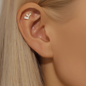 Detail of s925 silver clover ear stud with baguette-cut zircons and screw back design