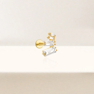 Detail of gold flat back cartilage stud with four rectangular cubic zirconia stones