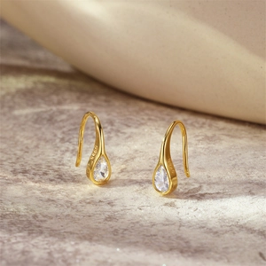 Close-up of gold-plated 925 silver teardrop earrings with sparkling marquise zircon