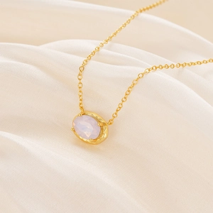 Close-up of s925 sterling silver necklace with textured oval pink opal stone pendant