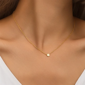 Close-up of minimalist gold S925 sterling silver necklace with star zircon pendant on neck
