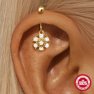 S925 sterling silver snowflake stud earrings with crystals on a female model's ear