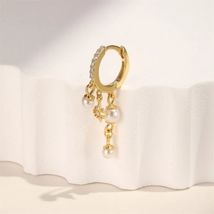 Gold earring hoop detail featuring micro-paved zircons, hanging pearls, and a star charm